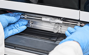 Lab worker handling an HPLC column.