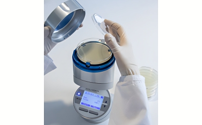 Viable Air Sampling with the MAS-100 NT® active air sampler Scientist performing viable air sampling with the MAS-100 NT<sup>®</sup> air sampler and a settle plate