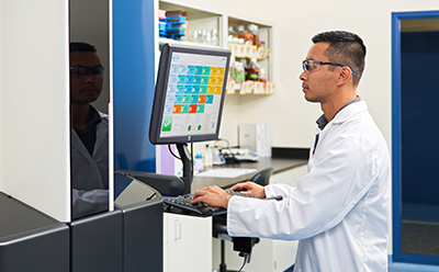 A laboratory technician operating the Growth Direct® System, showcasing trusted automation that frees up analyst time and standardizes workflow.