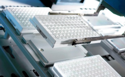 An image of multiple MultiScreen® 96-well plates being handled by a MultiScreen® Plate Machine.