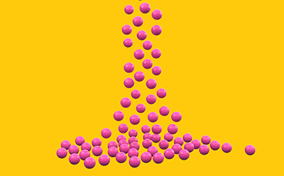 Granulated Materials Small beads falling on yellow background