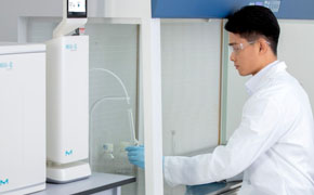 Scientist presses foot pedal to dispense purified water