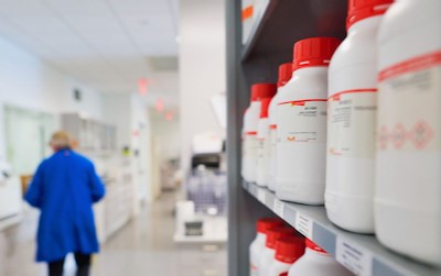 shelves with red capped bottles in a laboratory setting