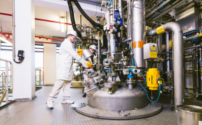 Scientists in production facility performing quality control and testing on production materials and bulk chemicals