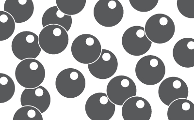 Close-up view of synthetic activated carbon particles, showcasing their spherical shape and dark coloration against a white background.