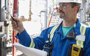 Man Checking Equipment Technician checking equipment in industrial site