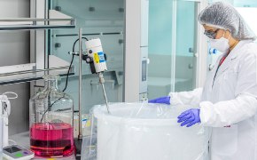 A picture showing an operator manipulating a mixer to perform a hydration protocol for culture media.