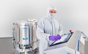 A photo showing an operator manipulating the control system of a single-use mixer.