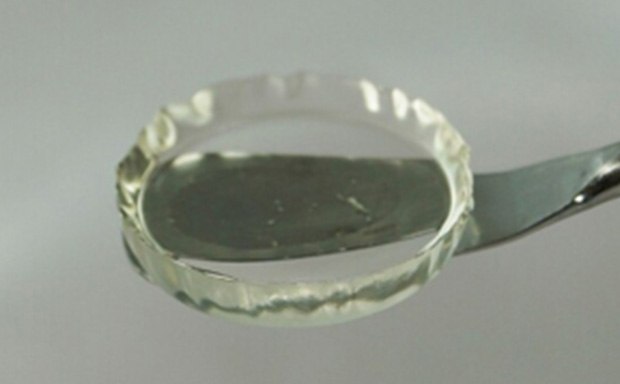 3D Hydrogels Close-up photo of a transparent, gel-like substance neatly contained within a circular glass dish held by a metal spoon, a sample of a hydrogel