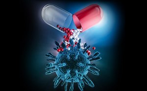Illustration of a capsule releasing small drug particles toward a biological target structure.