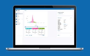 A laptop displaying a data analysis interface on a blue background. The screen shows a colorful graph with a prominent peak in pink, along with data tables below it highlighted in green, blue, and pink. On the left side, there are navigation options, and on the right side, there is a panel with detailed information about the analysis.