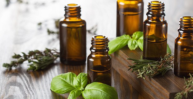 Essential Oils Essential oils bottles with herbs