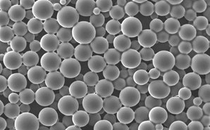 Image of API-loaded PLGA microspheres Close-up grayscale of numerous spherical microspheres with a smooth surface, varying slightly in size and densely packed together, representing API-loaded PLGA (poly(lactic-co-glycolic acid)) microspheres used in pharmaceutical applications for controlled drug release.