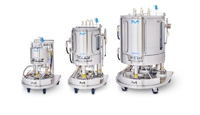 Three Mobius Single-Use Bioreactors (10 L, 100 L, 500 L) aligned next to each other. Each bioreactor consists of a cylindrical vessel with multiple ports and tubes attached, mounted on a wheeled support structure for mobility.