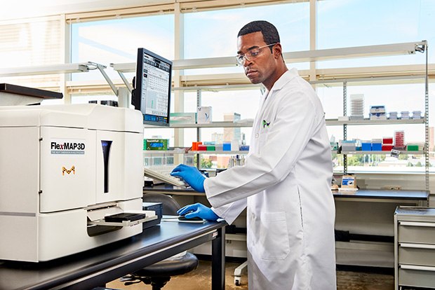 MILLIPLEX® Multiplex Biomarker Analysis Image of a scientist in the lab performing MILLIPLEX® multiplex biomarker analysis which can be applied to cosmetics and personal care product research.